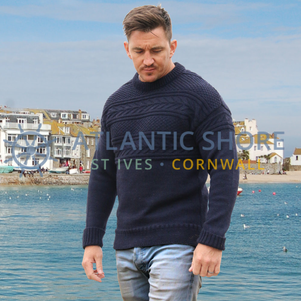 A folded traditional Cornish guernsey in cream British wool, photographed on the Atlantic Shore counter